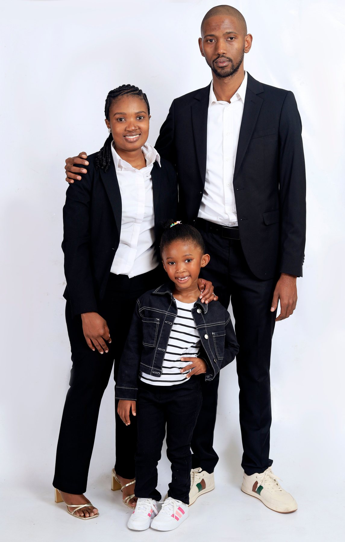 A family standing together in formal clothing