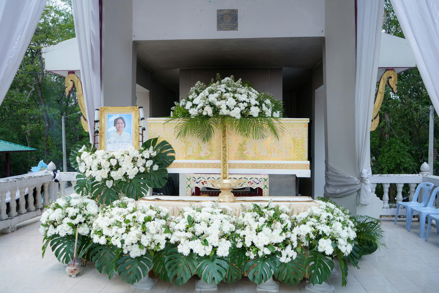 A dignified funeral setting with white flowers